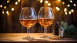 Two glasses of beer on wooden table with Christmas lights. bokeh background. Little pine branch on the table.