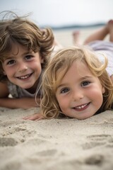 Sticker - two young children smiling as they are lying down on the beach