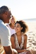 © OMD - cropped shot of a young girl spending time with her parents at the beach