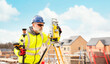 © Iryna - Surveyor builder site engineer with theodolite total station at construction site outdoors during surveying work
