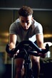 © OMD - shot of a young man working out on an exercise bike