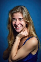 Wall Mural - happy, smile and portrait of woman in studio isolated on a blue background with motivation