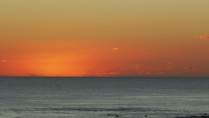 Wall Mural - beautiful evening sunset in the atlantic ocean at portugal coast. surfers ride the waves.