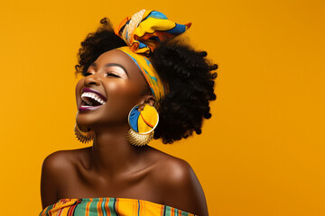 portrait of african american woman in turban traditional clothes laughing over yellow color backgrou