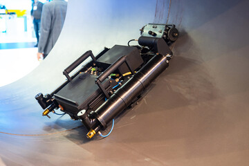 Poster - Soldering robot inside pipeline. Stand-alone pipe testing equipment. Automated soldering machine inside pipe. Soldering robot in large diameter pipe. Pipeline construction process. Engineering tech