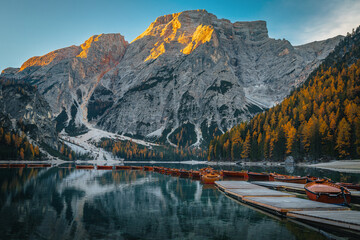  Anchored wooden boats on the lake Braies at sunrise, Dolomites