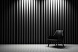 Black armchair in a room with striped wall