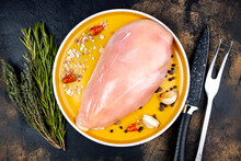 Seasoned Chicken Fillet Top View On A Round Orange Plate, Raw Dietary Chicken Meat
