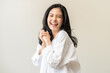 © KMPZZZ - Smile positive, happy asian young woman wearing casual shirt, portrait of beautiful female with black long hair feeling prond, standing gesture cheerful looking at camera, isolated on white background