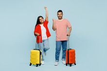 Traveler Winner Indian Man Woman In Red Casual Clothes Hold Suitcase Bag Isolated On Plain Blue Color Background Tourist Travel Abroad In Free Spare Time Rest Getaway Air Flight Trip Journey Concept