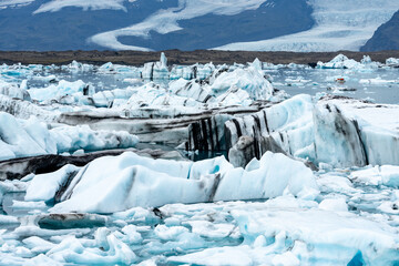 Wall Mural - Jokulsarlon glacial lake in Iceland, chunks of blue icebergs, cold landscape in Europe