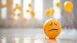 Emoticon face on a yellow balloon. The concept of depression.