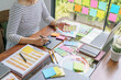 © Charlie's - Teamwork brainstorming Creative idea Business project. Business People meeting taking notes while discussing with Color swatch samples to share idea