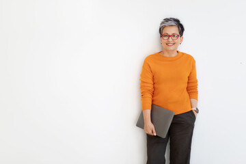 Successful middle aged lady posing with laptop on white background