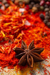 Wall Mural - anise star and variety of spices at table background. Cooking food ingredients