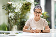 © Prostock-studio - Happy middle aged woman manager enjoying coffee break at office
