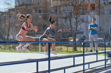 Sticker - Smiley fit sportsgirls doing jumps. Their male friend is taking a break and watching them