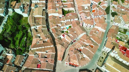 Wall Mural - Grazalema, Andalusia. Aerial view of whitewashed houses sporting rust-tiled roofs and wrought-iron window bars