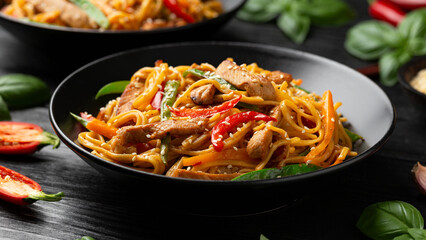 Wall Mural - Stir fry chow mein noodles with pork and vegetable in black bowl. asian style food