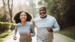 © OpticalDesign - An african american couple of middle aged adults running in the morning, healthy lifestyle jogging, happy run