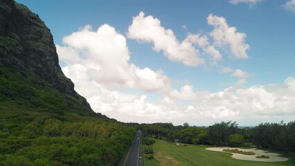 Canvas Print - Golf course along a beautiful island coastline, drone point of view