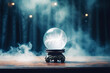 Fortune Teller Crystal Ball in Blue Smoke on Table Against Dark Forest