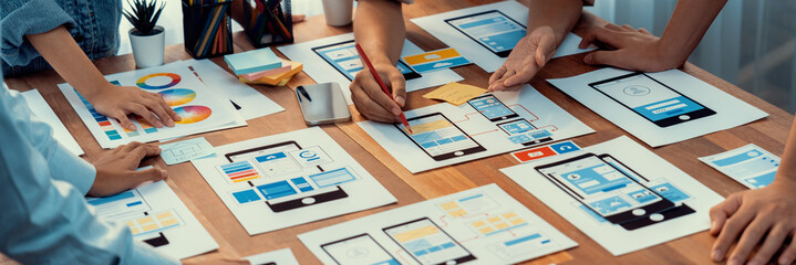 Poster - Panorama shot of front-end developer team brainstorming UI and UX designs for mobile app on paper wireframe interface. User interface development team planning for user-friendly UI design. Scrutinize