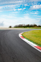 Wall Mural - Motor sport asphalt race track and curbs with skid marks, low angle view