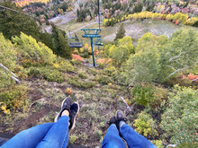 Personal Perspective View Of Two Women's Legs Outstretched On A Ski Lift, Sundance, Utah, USA