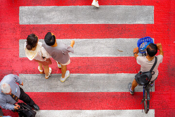 Wall Mural - Top view crowd of people walks on a business street pedestrian in the city