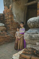  little girl  Thai traditional dress  with ancient ruin