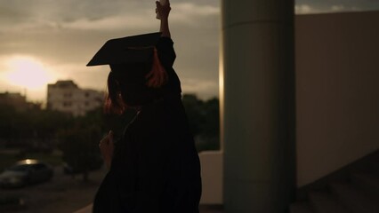 Poster - Study, education, university, college, graduate concept. Portrait of a cheerful Asian female in academic gown and graduation hat standing outside college.