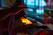 Holy fire of pradeep or oil lamp used in hindu puja. Hands of devotee seen taking blessings from the warmth of the holy flame as part of the aarti ritual.