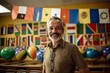 Senior man in a classroom with many balloons and flags of different countries