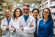 Group of pharmacists standing together and looking at the camera in a chemist. Group of healthcare professionals working in a pharmacy.