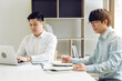 © wutzkoh - Businessmen working together in the office.