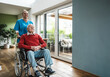 © Westend61 - Happy nurse taking care of senior man sitting in wheelchair at home