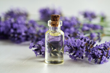 Wall Mural - Lavender essential oil on a white table