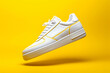 A clean white sneaker on a yellow background after cleaning. Cleaning soles, washing shoes, clean shoes.