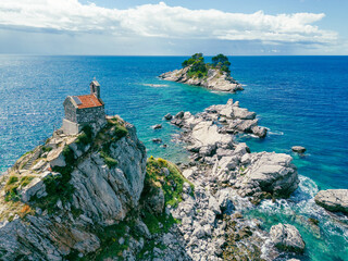 Poster - Church on the rock on Katic islet in Petrovac na Moru Aerial View. Beaches and coastline of the Adriatic Sea at summer time. Natural landscapes of Montenegro. Balkans. Europe.