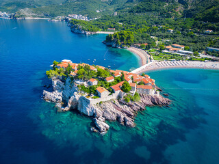 Island of Sveti Stefan near Budva in Montenegro. Beaches and coastline of the Adriatic Sea at summer time. Natural landscapes of Montenegro. Balkans. Europe.