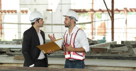 Wall Mural - building and construction worker, Hiapanic latin male wearing safety hard hat helmet standing at Prefabricated concrete walls Industry Manufacturing Factory. Unity and teamwork