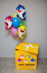 Wall Mural - a big yellow box with balloons, a set of balloons baby sharks