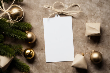 A mock-up of a white tag card with a gift box and a garland with Christmas tree toys and cones