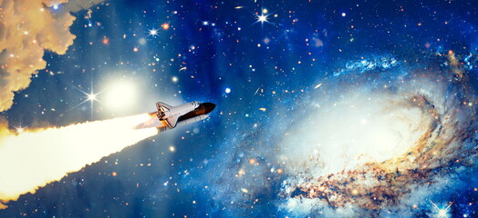 Wall Mural - shuttle launch in the clouds to outer space. dark space with stars on background.spaceship flight. e