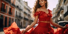 Beautiful Woman Dancing Flamenco In The Square. She Wears A Red Ruffled Dress.