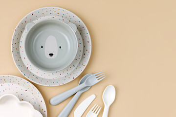 Cute children's plates and dishes shape of a bear. Creative serving for baby. Concept of kids menu, nutrition and feeding.