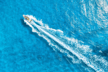 Wall Mural - aerial view on fast boat on azure mediterranean sea at sunny day. fast ship on the sea surface. seas