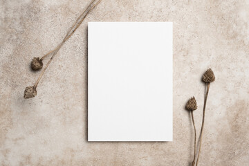 Blank invitation or greeting card mockup with dry botanical decor, white card mock up with copy space