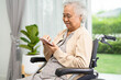 © amazing studio - Asian elderly woman patient use mobile phone while sitting and happy on wheelchair at home.
